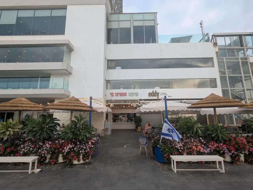 Aroma Espresso Bar with flower planters on the Gordon Beach promenade