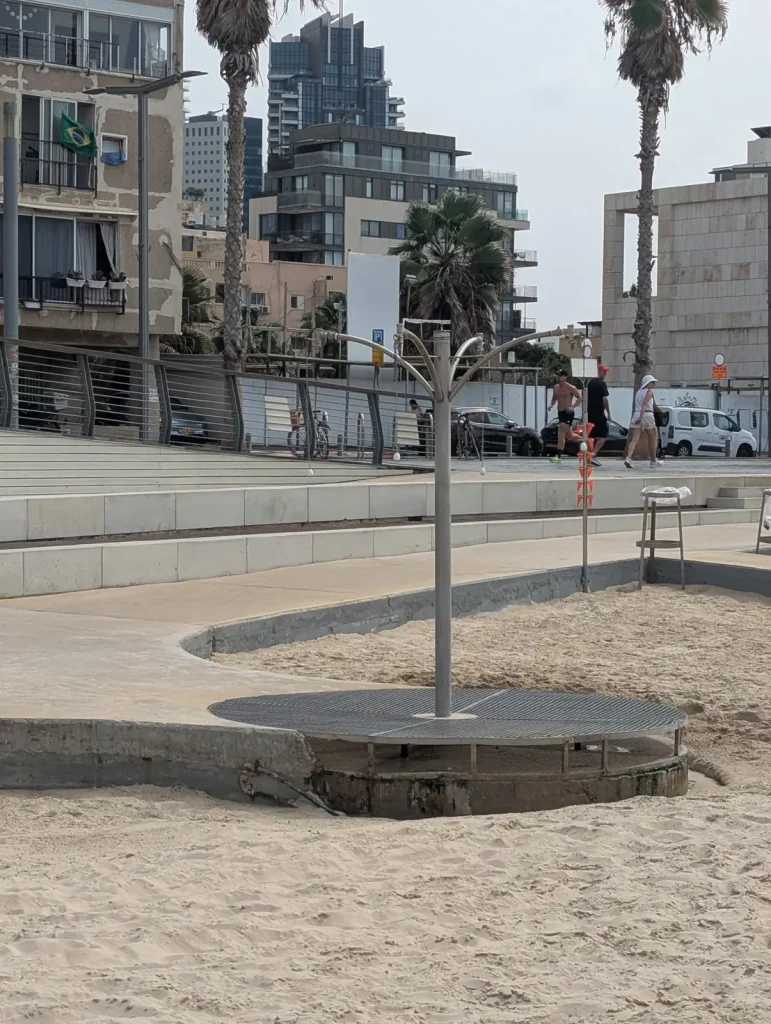 Shower post on a round platform at a Tel Aviv beach