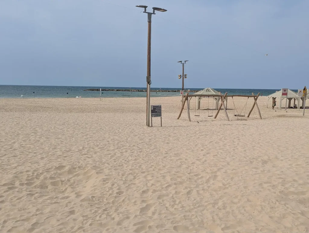 Swings and shade huts on the sand