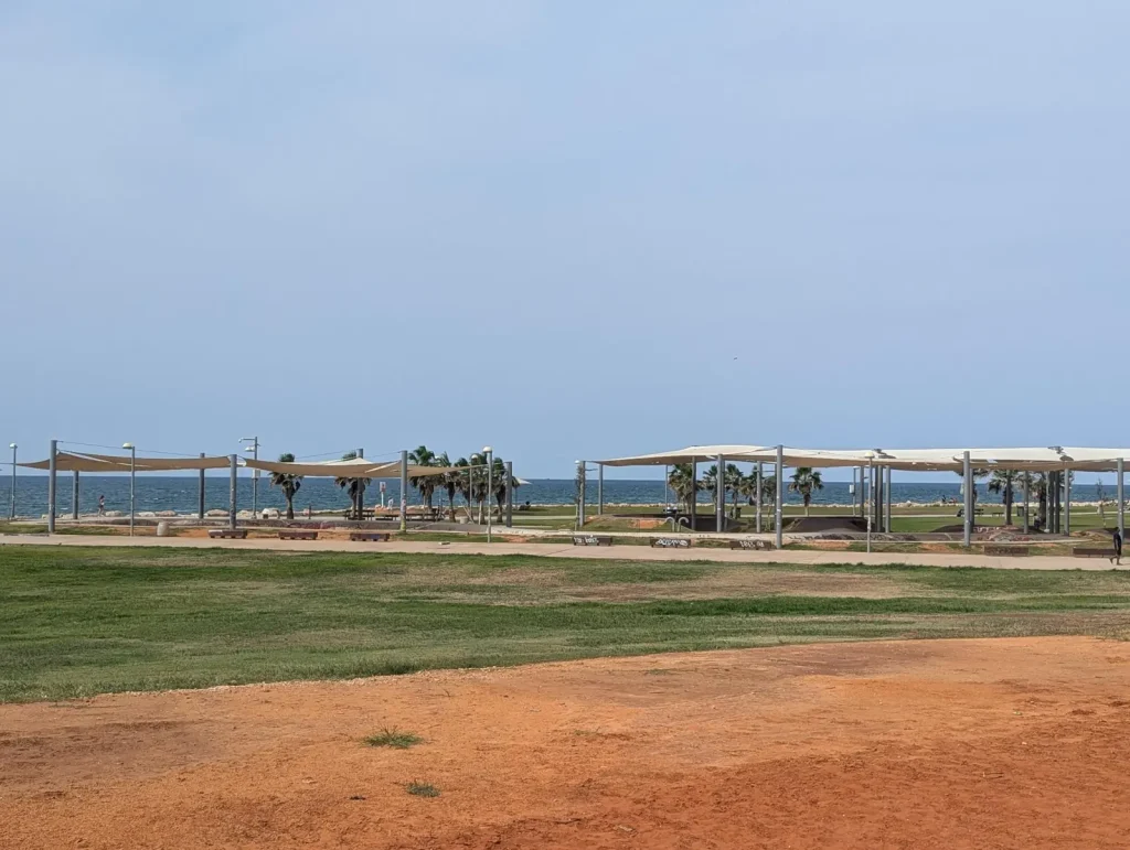 Shade pergolas along the seafront in Charles Clore Park