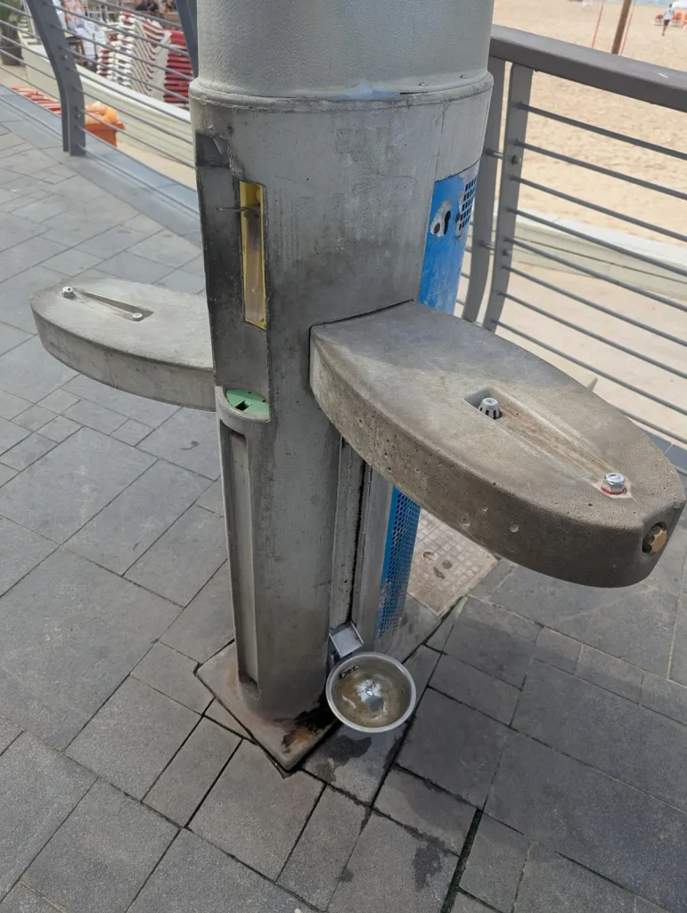 Close-up of a drinking fountain with a dog bowl on the promenade