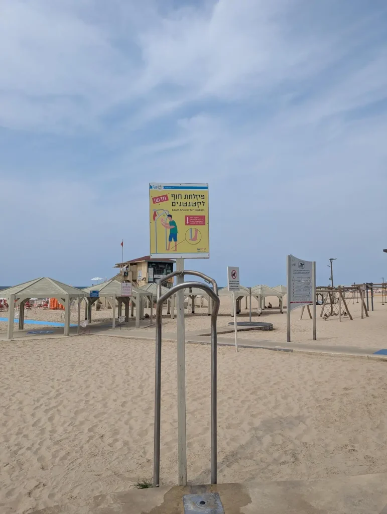 Beach shower with the lifeguard tower behind at Jerusalem Beach