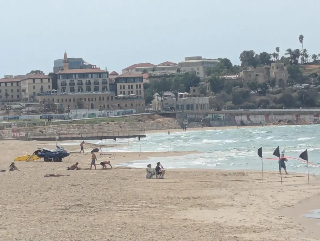 Maravi Beach with waves and Jaffa on the hill behind
