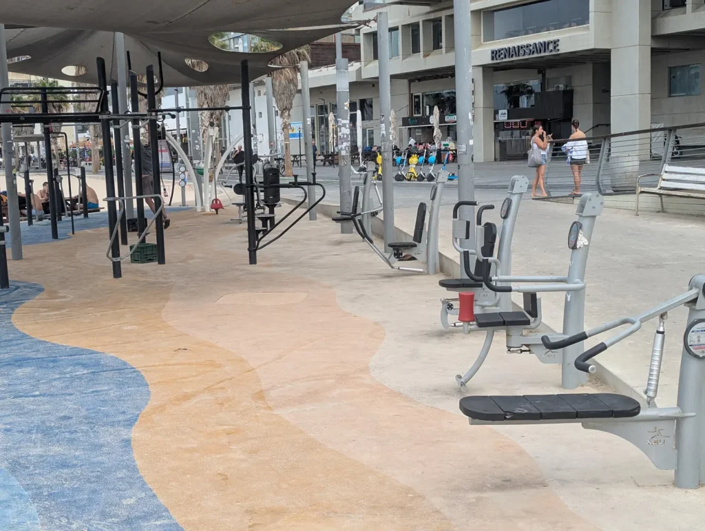 Outdoor gym machines on the Tel Aviv promenade in front of the Renaissance hotel
