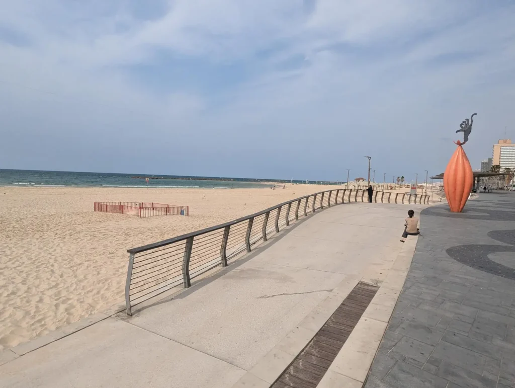 Promenade railing and orange sculpture along the Trumpeldor stretch