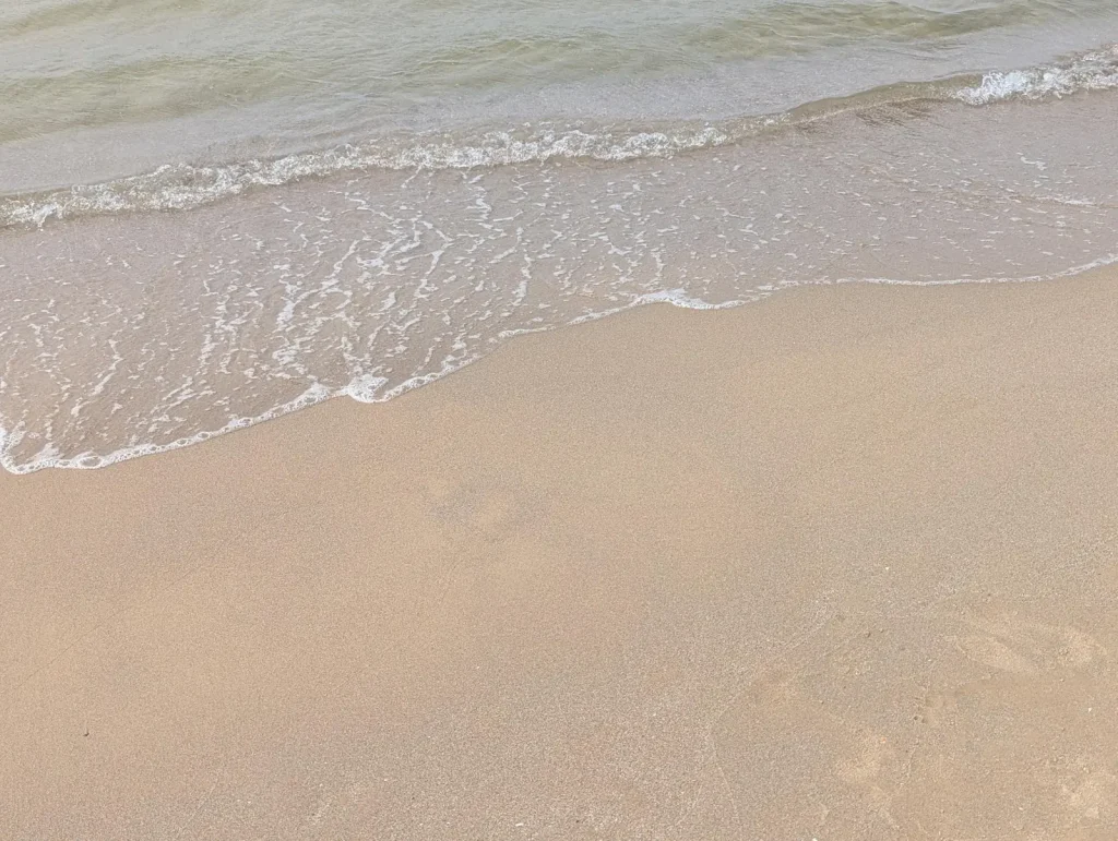 Clear water washing onto the sand at a Tel Aviv beach