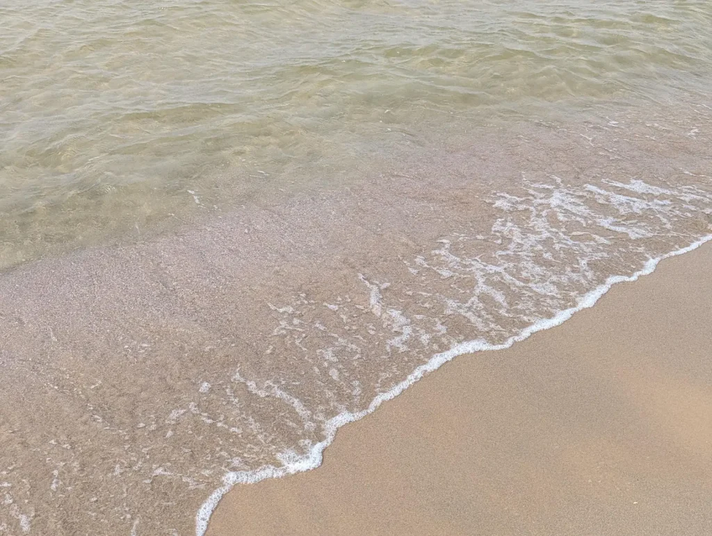 Close-up of shallow water on the sand at a Tel Aviv beach