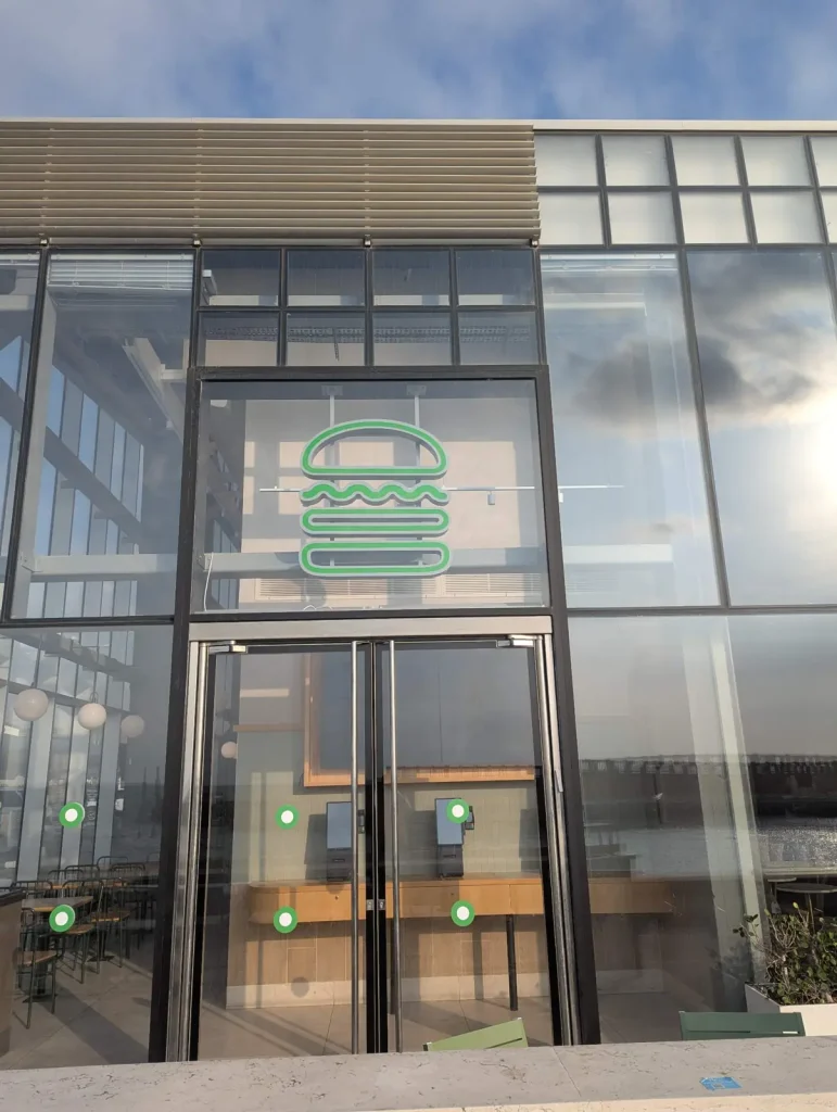 Shake Shack entrance with its green burger logo, Tel Aviv Port