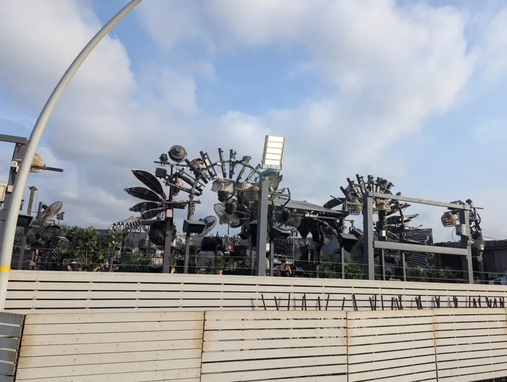Outdoor dance area of Shalvata with metal sculptures in daylight