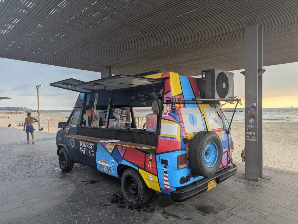 Colorful tourist information van on the promenade at Bograshov Beach